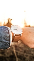 A Solavue watch paired with casual attire, worn on a wrist outdoors with soft sunlight.