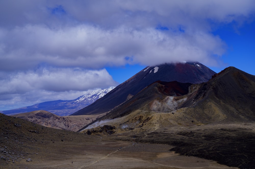 brown and black mountain under blue sky