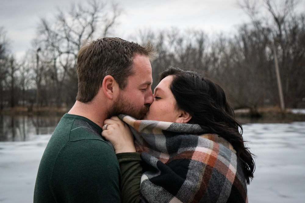 man and woman kissing during daytime