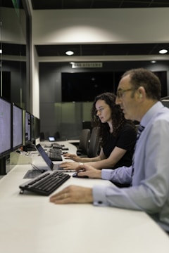 woman in black shirt using computer