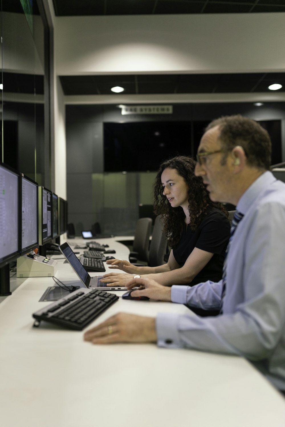woman in black shirt using computer