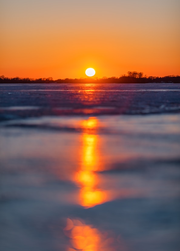 body of water during sunset