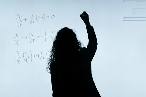 Engineering student writing equations
