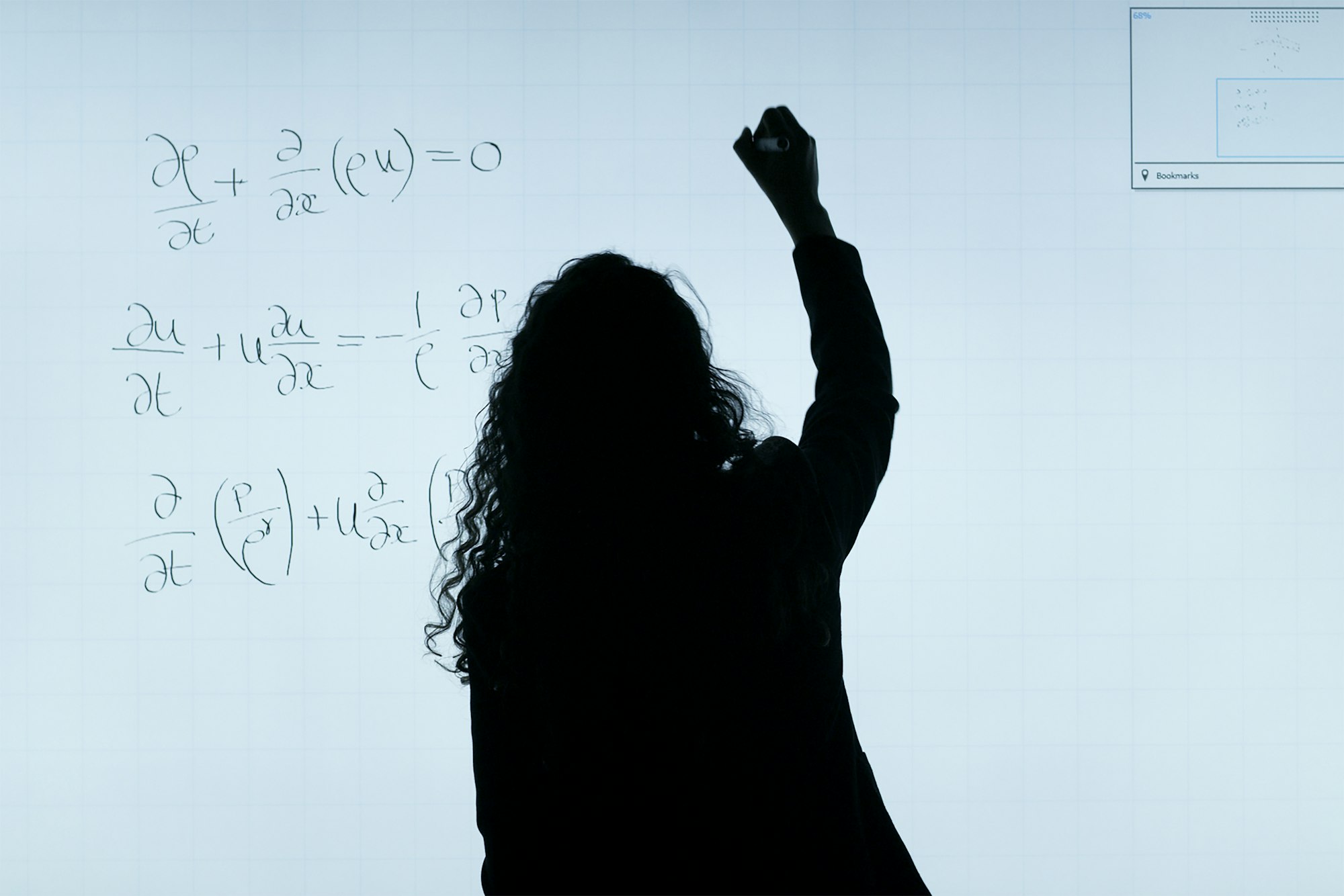 Female aerospace engineer writes equations