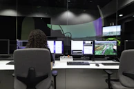 woman sitting on black office rolling chair in front of computer monitor