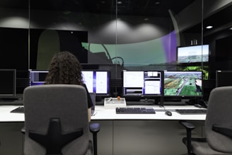 A cybersecurity expert analyzing network security on multiple monitors.