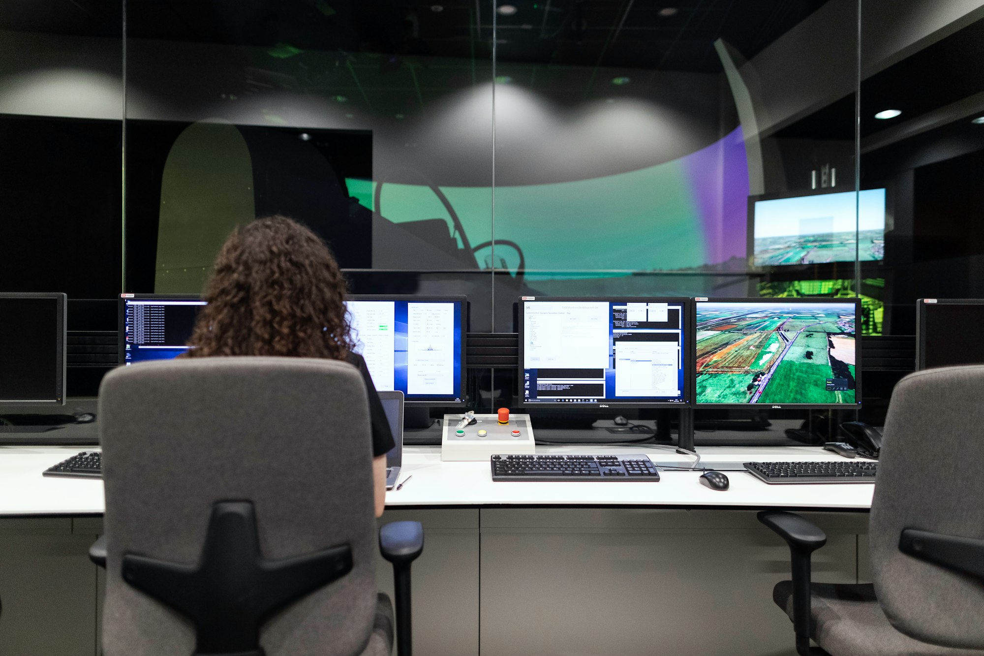 Female aerospace engineer monitors flight simulator