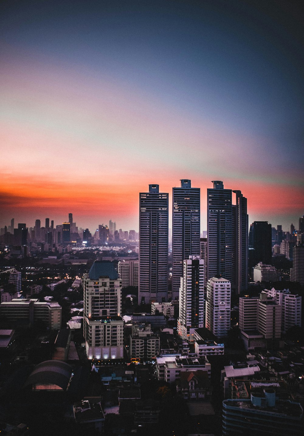 city skyline during sunset with orange sky