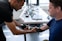 man in blue holding hand doing physiotherapy