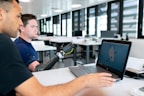 man in blue crew neck t-shirt using black laptop computer