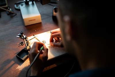 person holding black coated wire