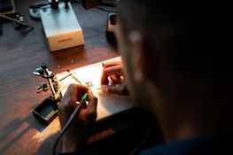 person holding black coated wire