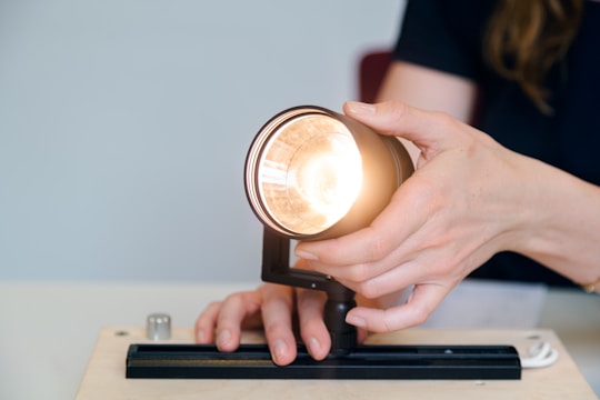 person holding black ceramic mug with brown liquid
