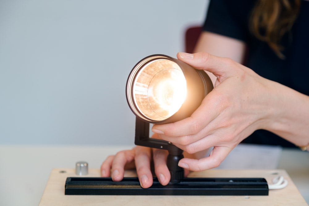 person holding black ceramic mug with brown liquid