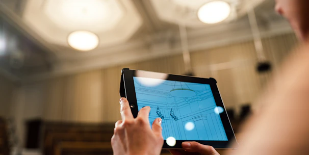 A professional architect reviewing cloud infrastructure diagrams on a digital tablet in a modern office.