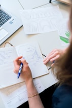 person writing on white paper