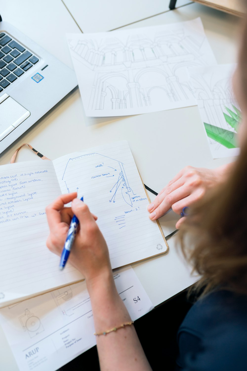 person writing on white paper