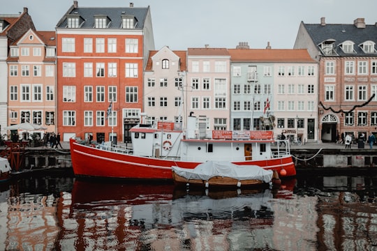 red and white boat on water in Holbergno 19 Denmark