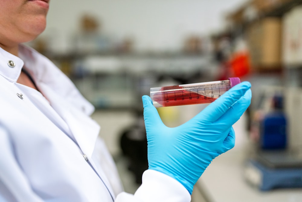 person holding clear plastic container