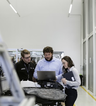 group of people sitting on chair in front of table with laptop computers