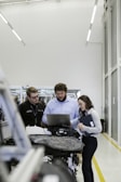 group of people sitting on chair in front of table with laptop computers