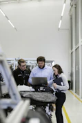 group of people sitting on chair in front of table with laptop computers