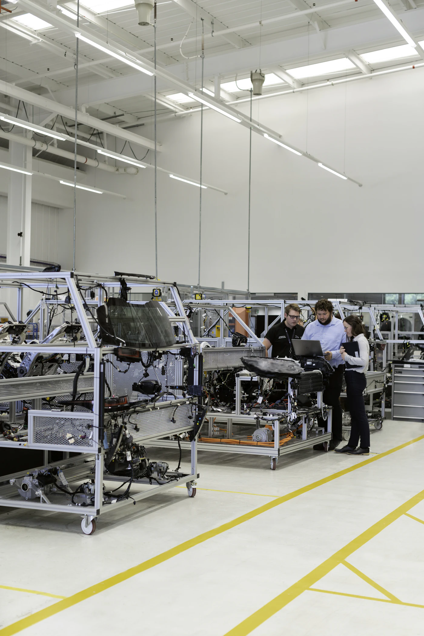 Engineers working on the floor of a manufacturing plant