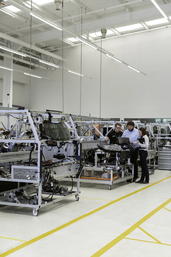 Engineers installing and commissioning equipment on a production line