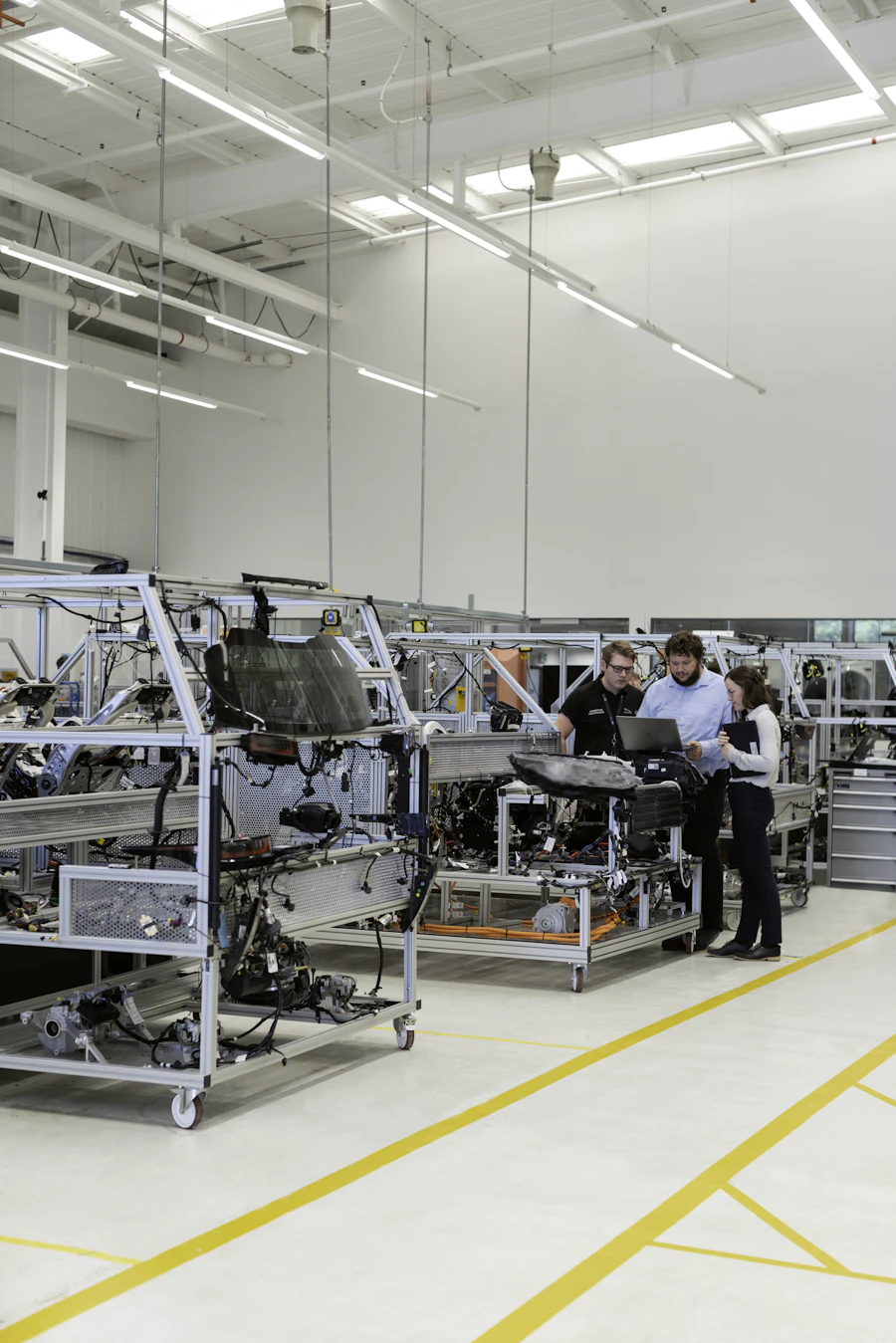 Engineers installing and commissioning equipment on a production line