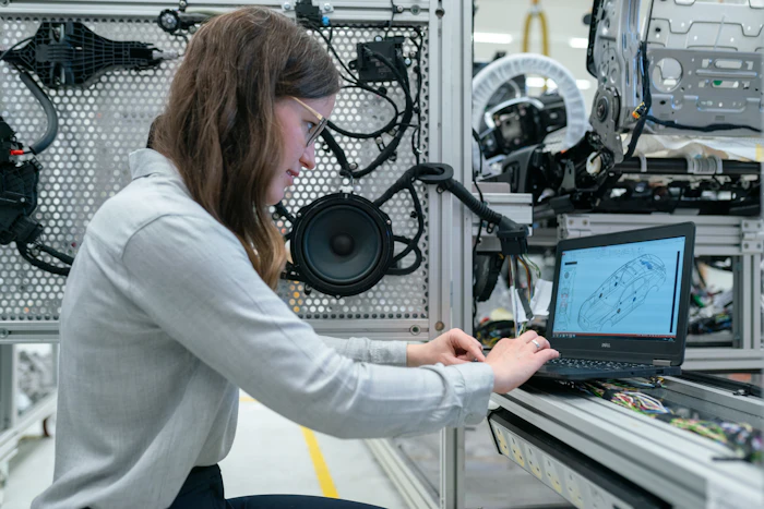 Engineer reviewing aerospace CAD drawing on laptop