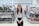 woman in white long sleeve shirt and black pants wearing black framed eyeglasses