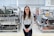 woman in white long sleeve shirt and black pants wearing black framed eyeglasses
