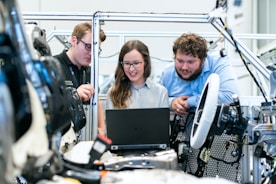 woman in blue long sleeve shirt sitting beside man in blue dress shirt