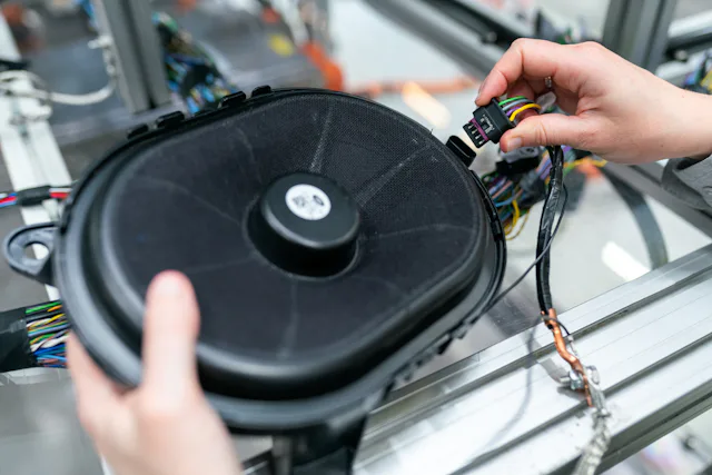 Person holding a black and yellow electrical testing device