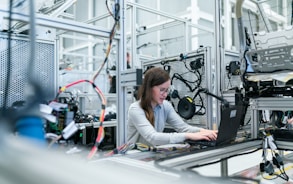 woman in white long sleeve shirt using black laptop computer