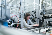 An engineer working on avionics systems in a high-tech lab.