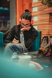 man in black jacket sitting on chair