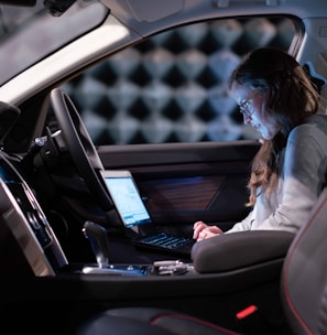 woman in white jacket sitting on car seat