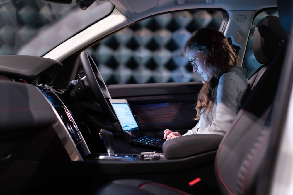 woman in white jacket sitting on car seat