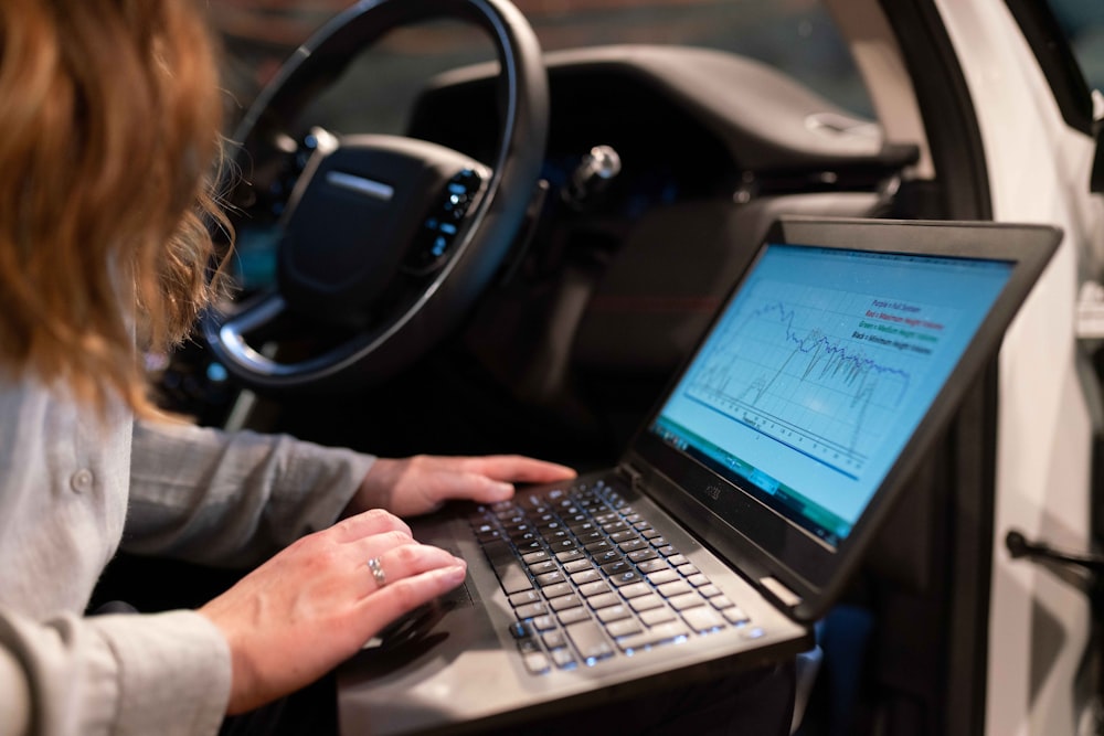 woman in gray long sleeve shirt using black laptop computer