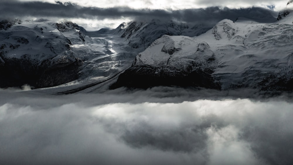 snow covered mountain under cloudy sky during daytime