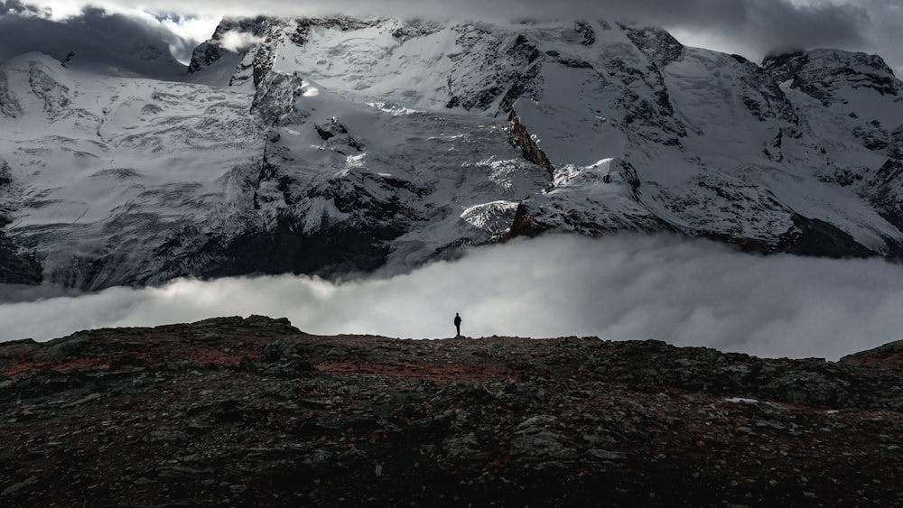 person standing on rock mountain