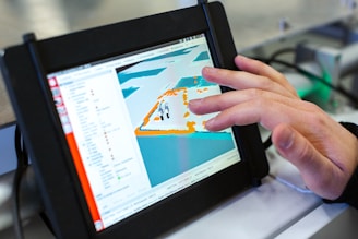 person holding black tablet computer