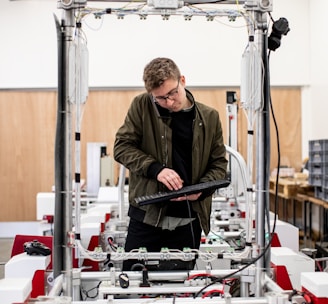 man in brown jacket using a machine