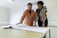 A friendly insurance broker discussing options with a client in a bright office.