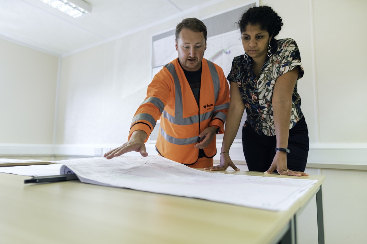 Homeowner discussing insurance claim with an expert at a kitchen table