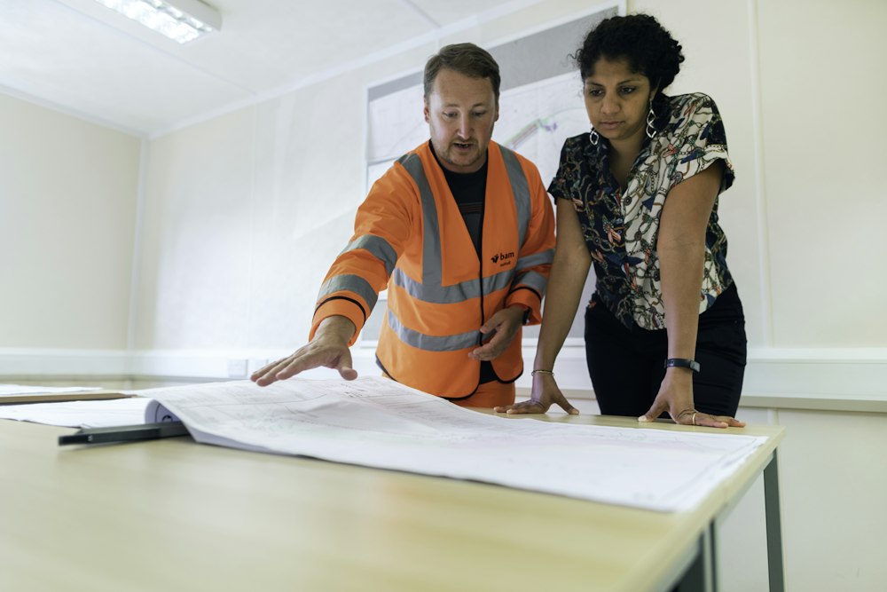 Quality controller reviewing requirements with a colleague