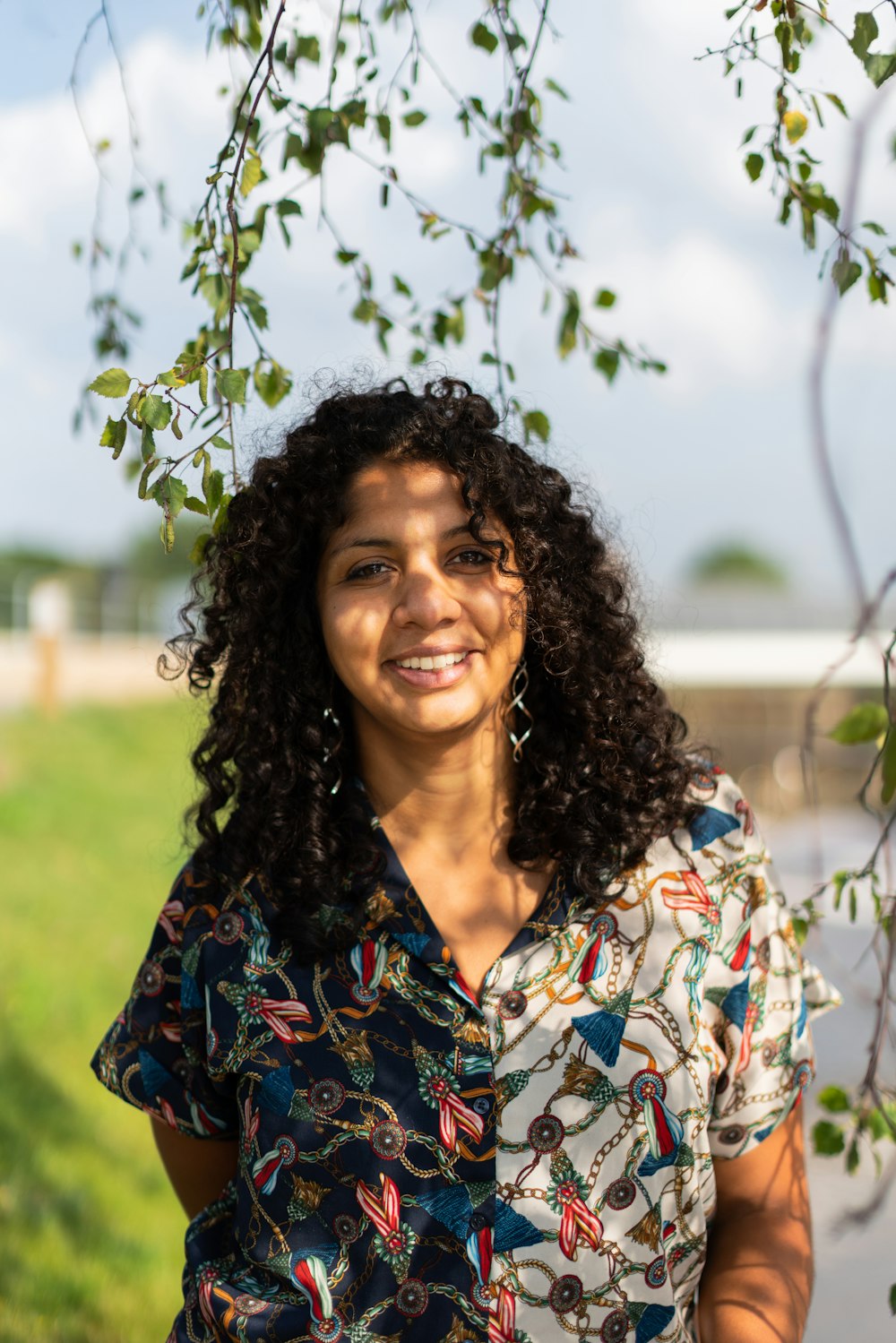 woman in blue and yellow floral shirt smiling