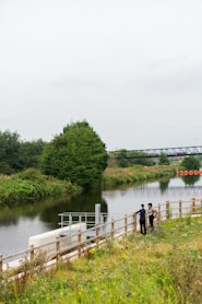 people walking on wooden dock over river during daytime