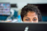 Close-up of a recruiter reviewing resumes with focused attention.